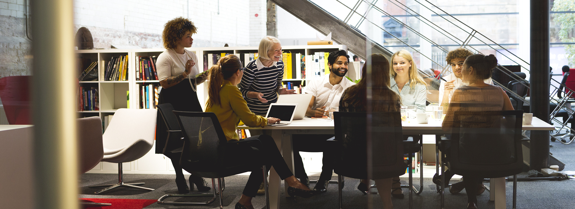 A group of people sitting in a library working on a project