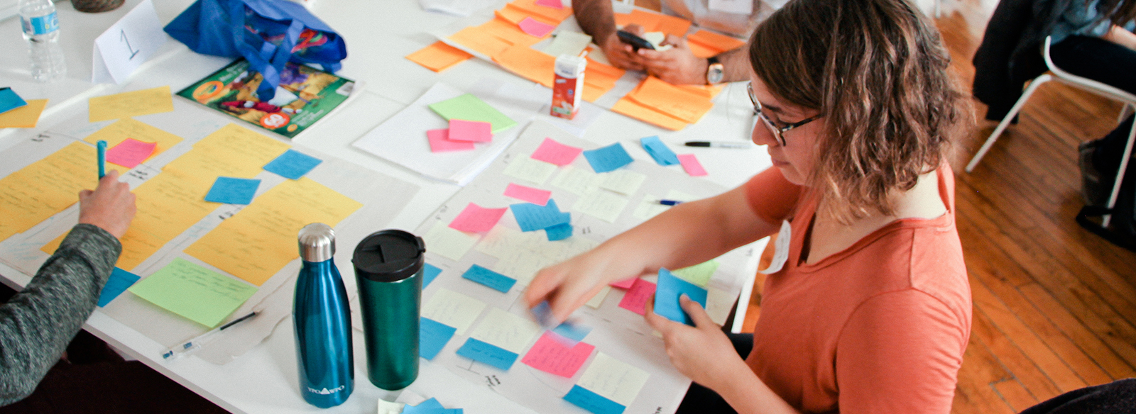 woman attaching paper notes on to a board