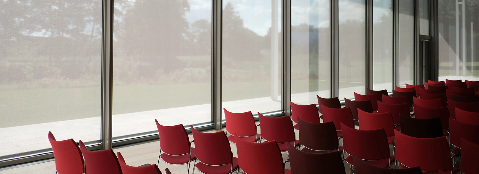 rows of red chairs set up for a conference