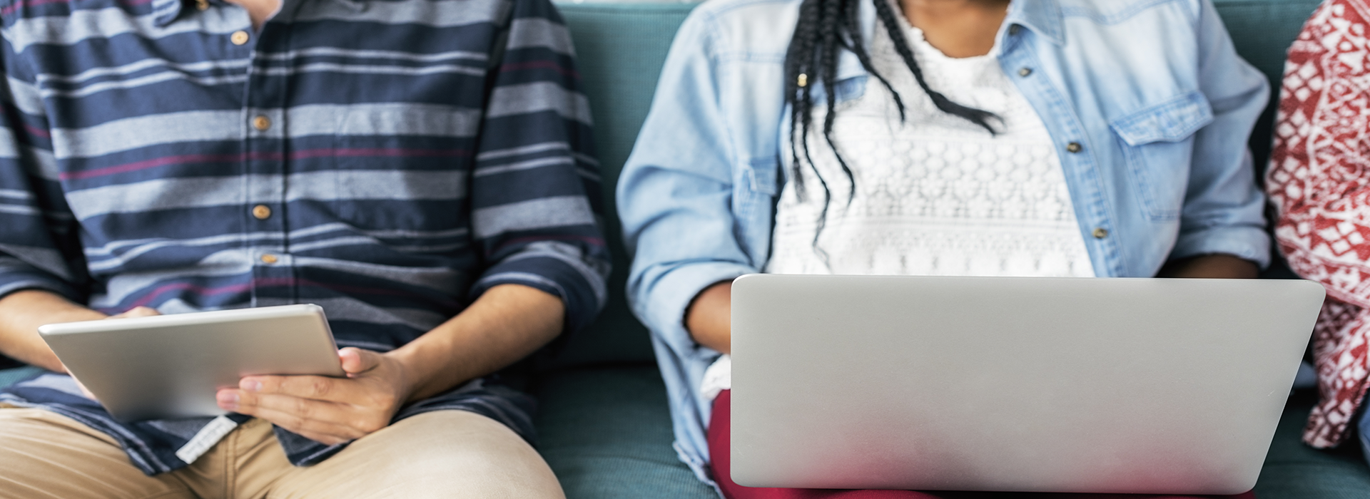 étudiants assis sur un canapé en utilisant un ordinateur portable