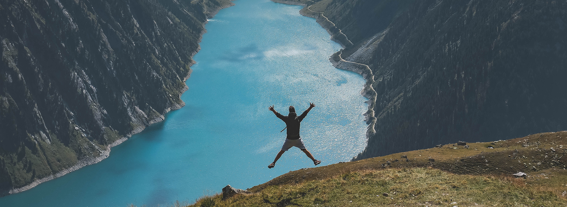 a man on a mountain jumping