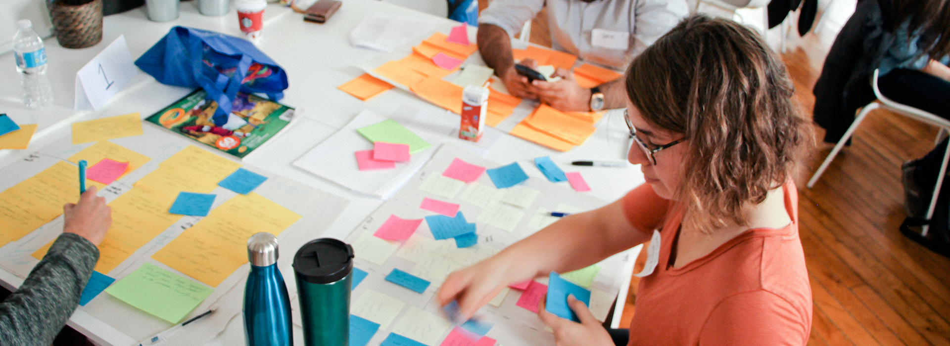 woman attaching paper notes on to a board