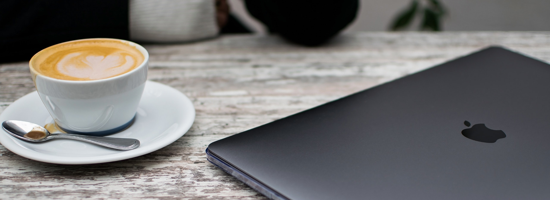 cup of coffee and laptop on a table