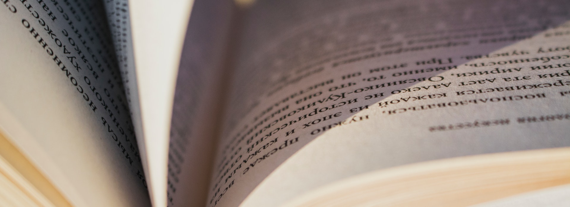 Close-up photo of an open book with yellowed pages