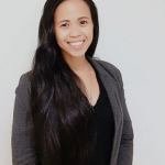 Smiling woman with long dark hair, wearing a black blazer