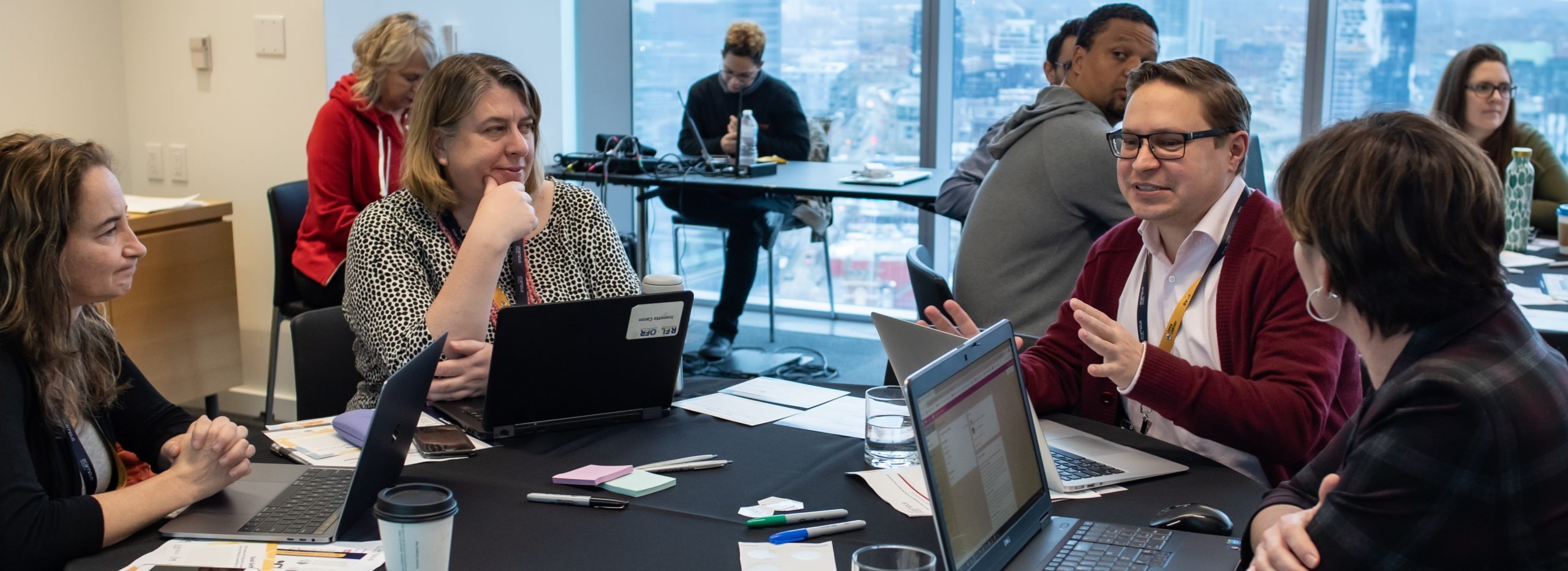 Several people sit at tables during a workshop