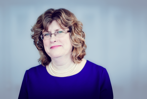 Headshot of a woman in blue shirt