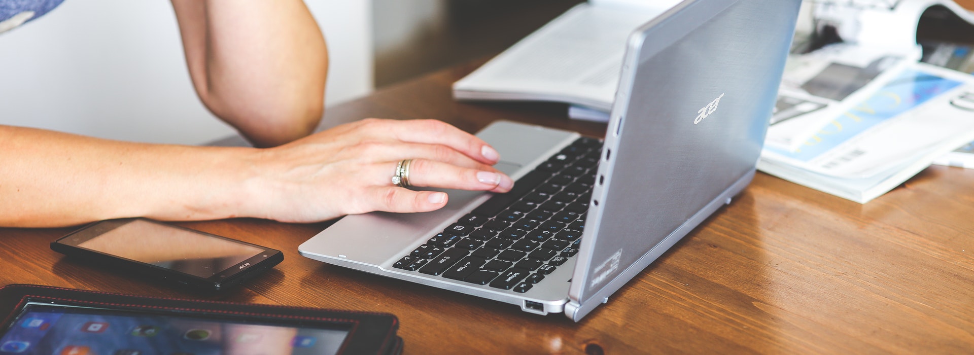 Photo of a hand typing on a laptop